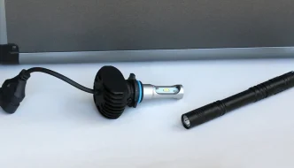 A flashlight and lightbulb on a table