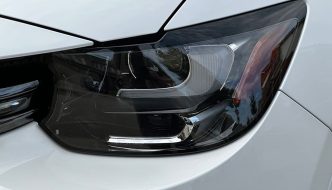 Closeup of a headlight on a white car